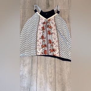 Beautiful soft blouse with floral pattern down front. With a knit navy on back.